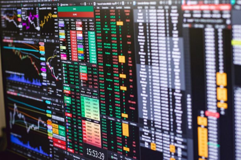 Financial charts and market depth data on multiple trading monitors