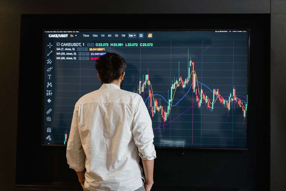 Disciplined trader reviewing trade journal and position sizing strategy on laptop